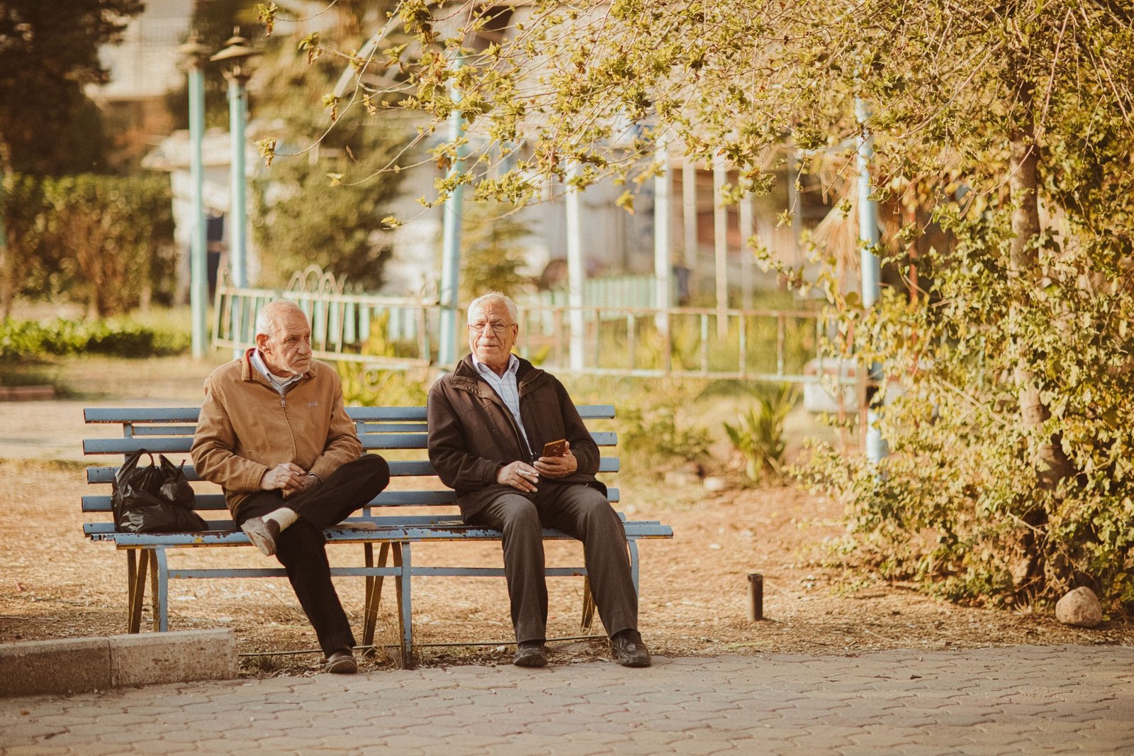 Senior citizens sitting together on a garden bench