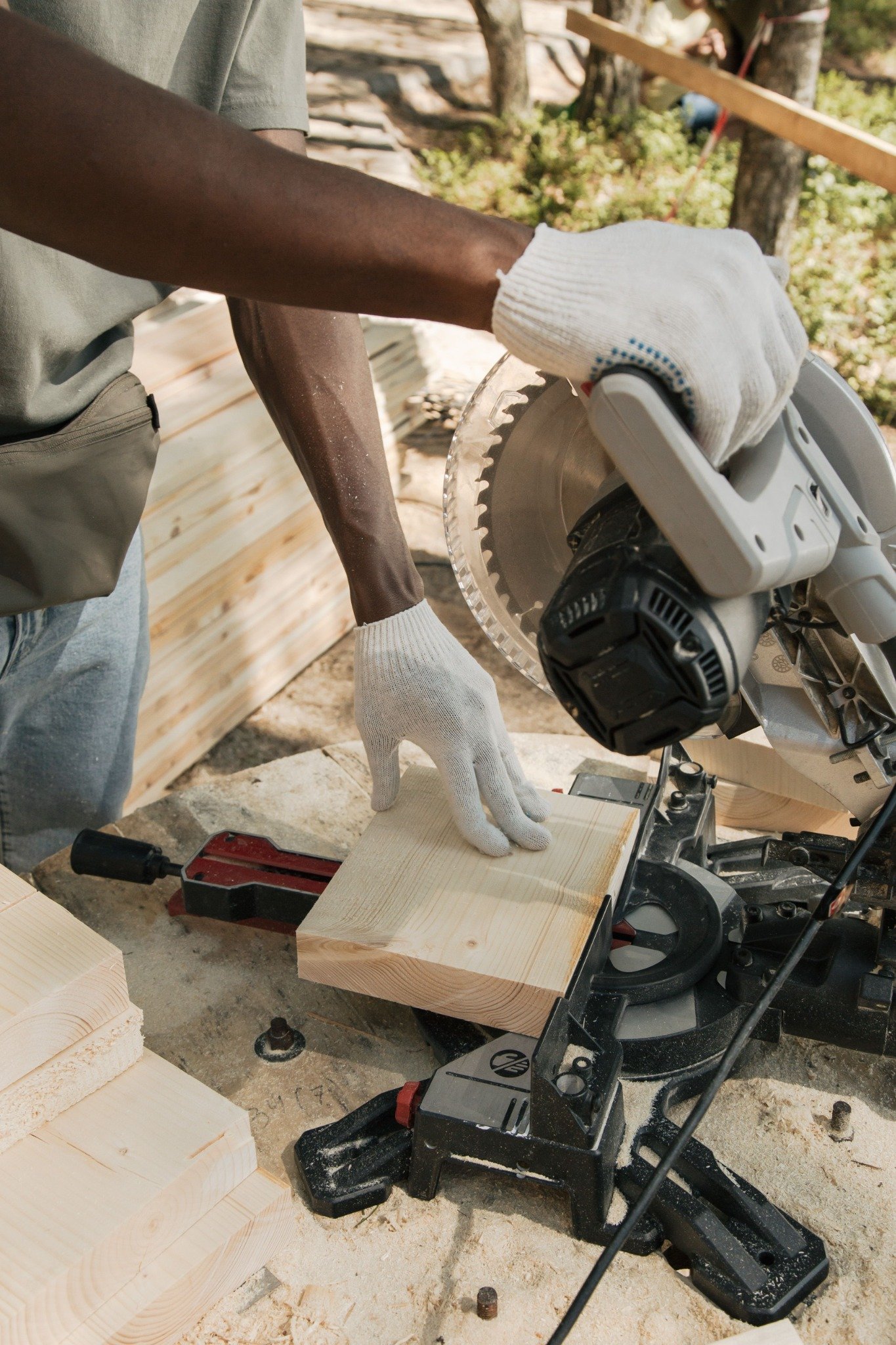 Craftsperson cutting timber for construction