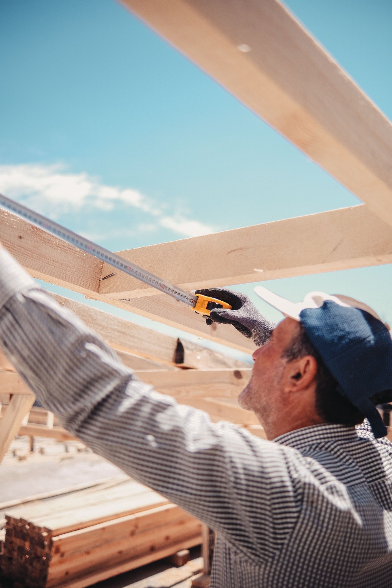 Builder measuring structural timber
