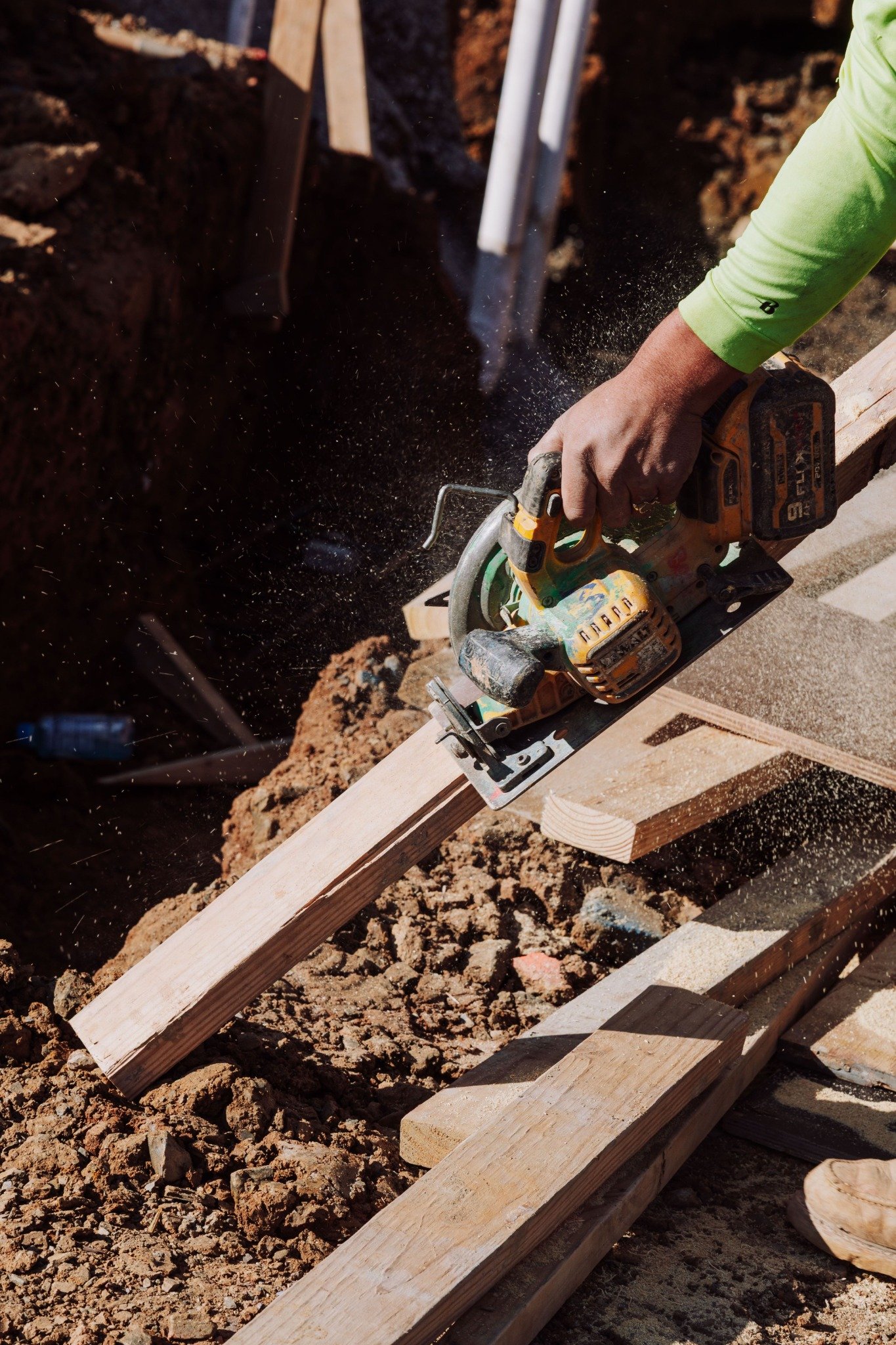 Construction worker using a power saw