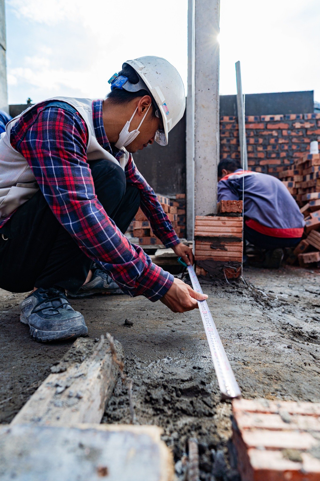 Engineer checking measurements at a building site